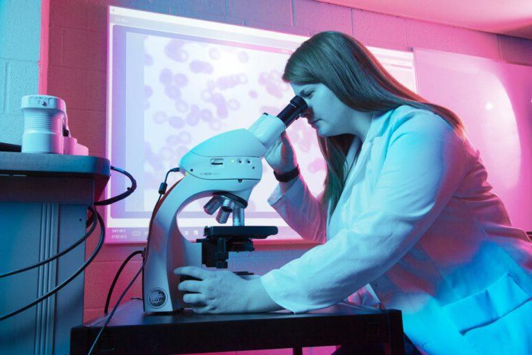 Student looking into a microscope